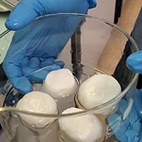 Bowl containing four mozzarella lookalike balls
