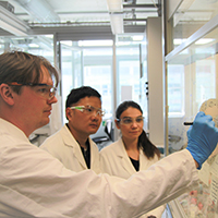 Dimitry and his team in front of white board