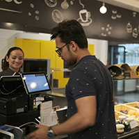 People queuing at cash till in cafeteria