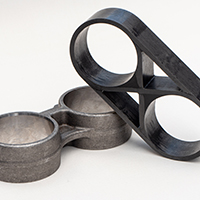 2 car parts: one made from metal, the other from CFRP