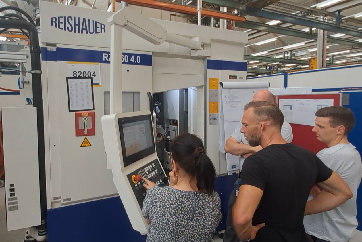 three people getting trained on a real machine